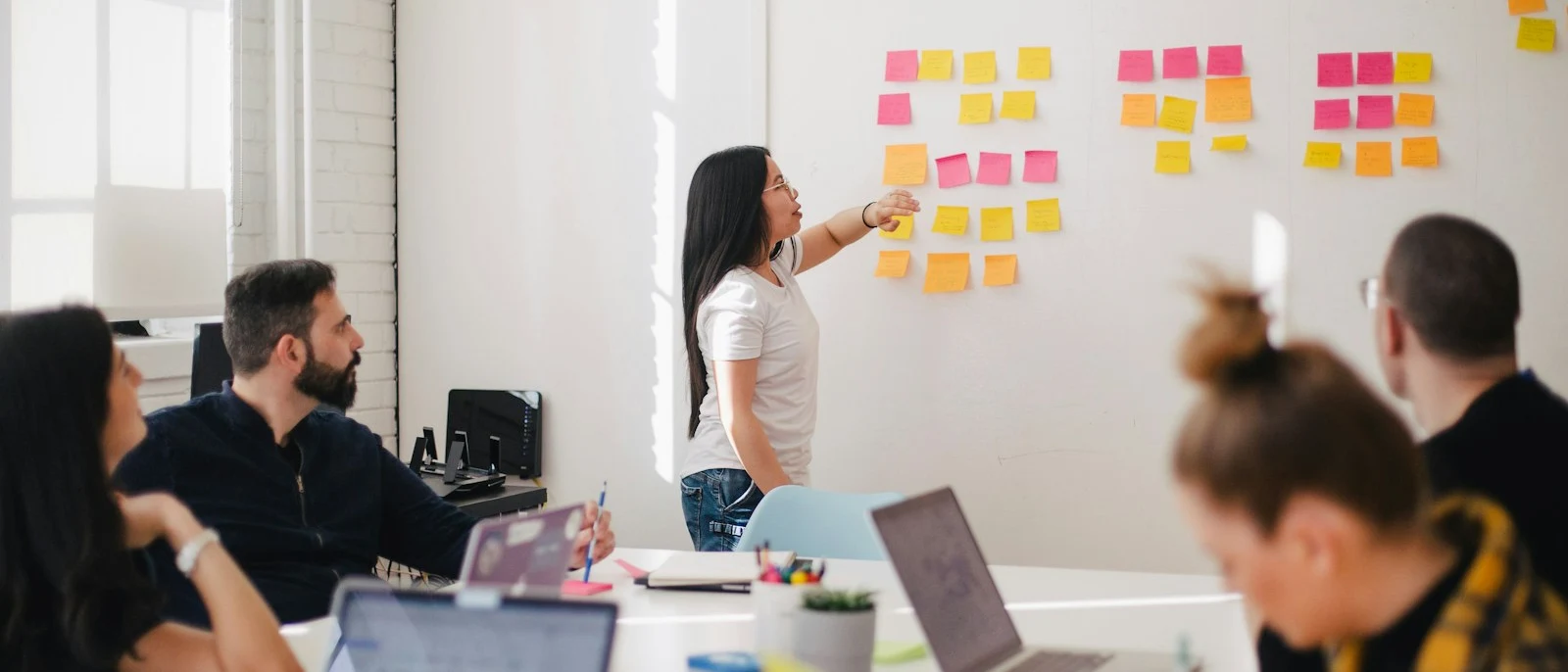 A collaborative team workshop with sticky notes and discussion