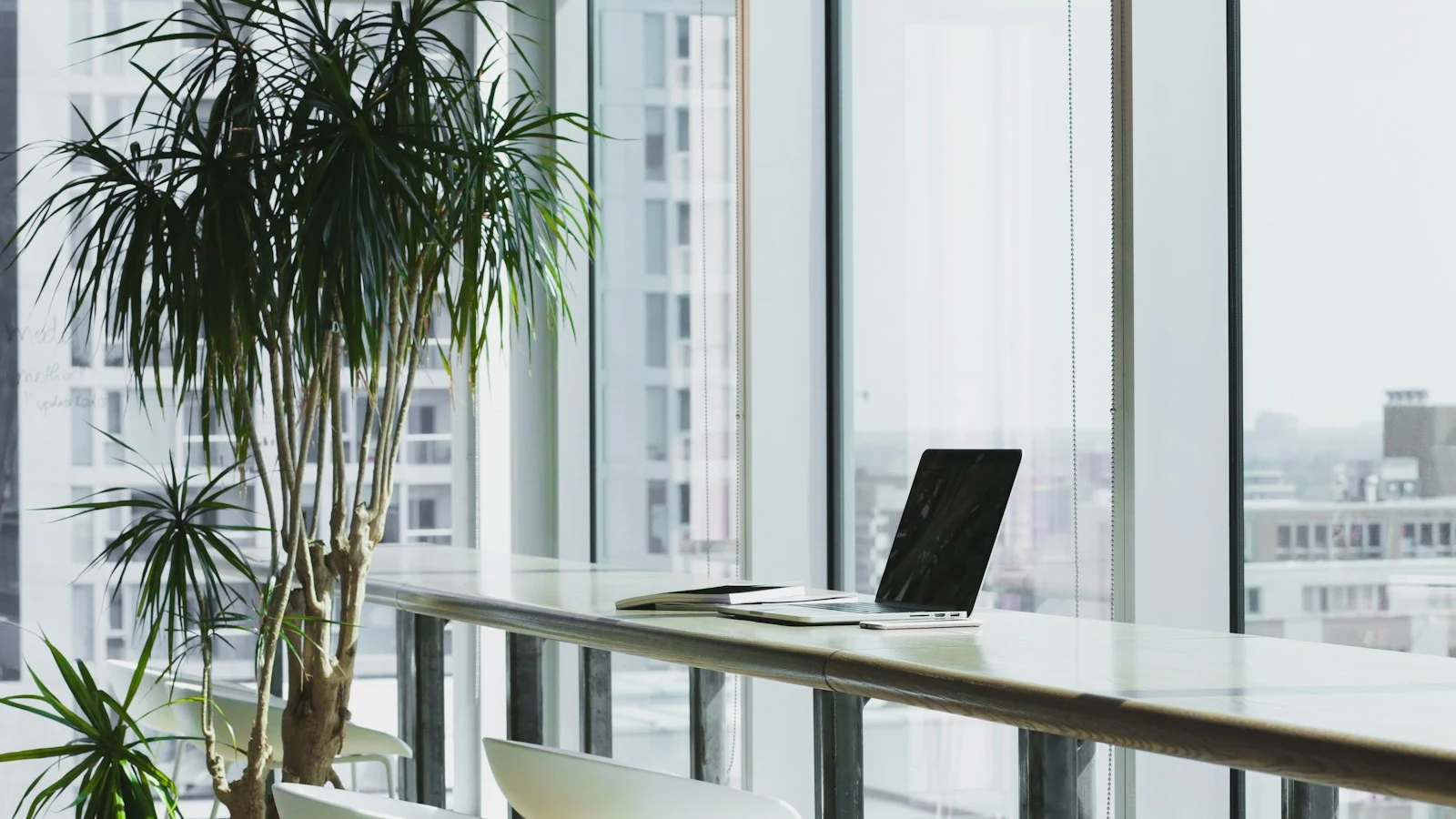 A clean desk with a laptop in natural light