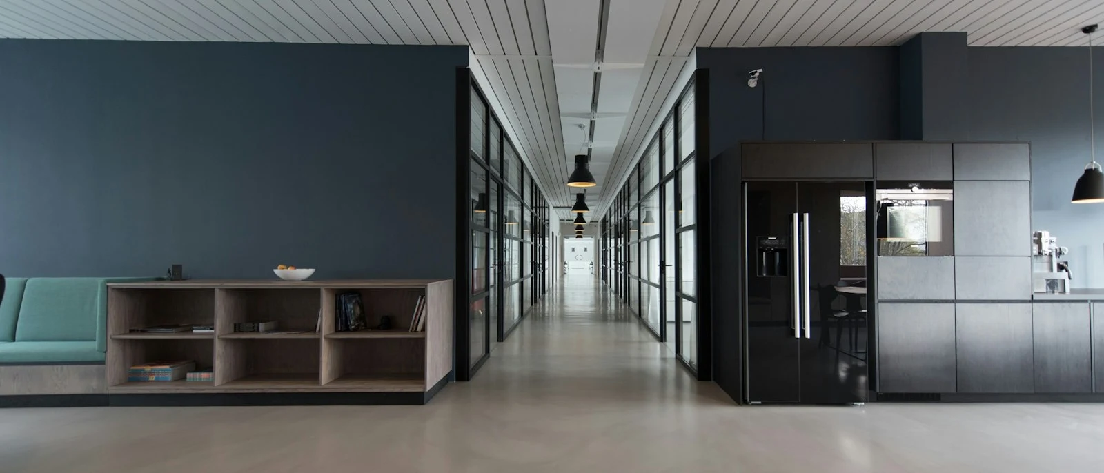 A calm modern office corridor and shared workspace