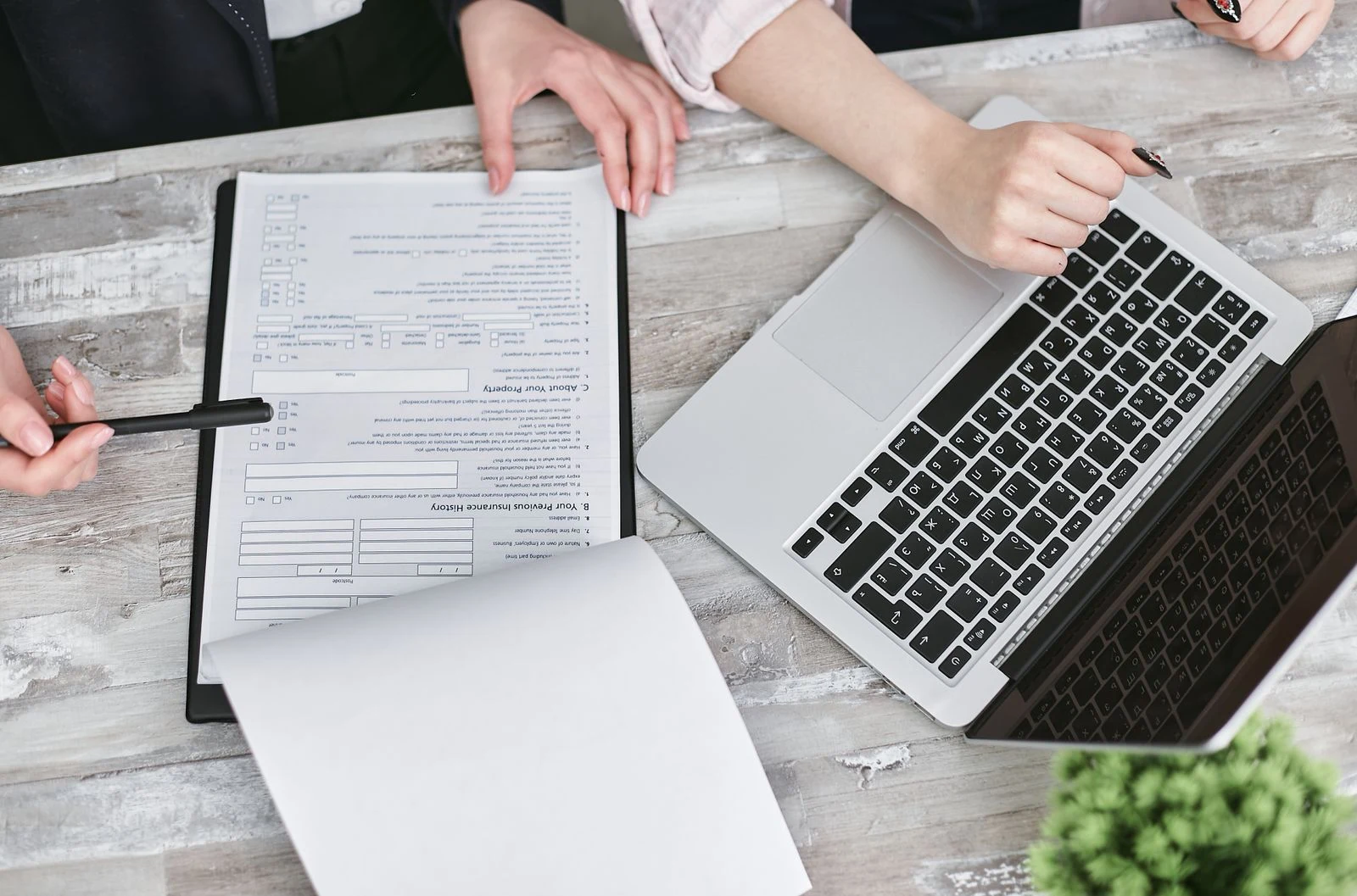 A business task being reviewed beside a laptop