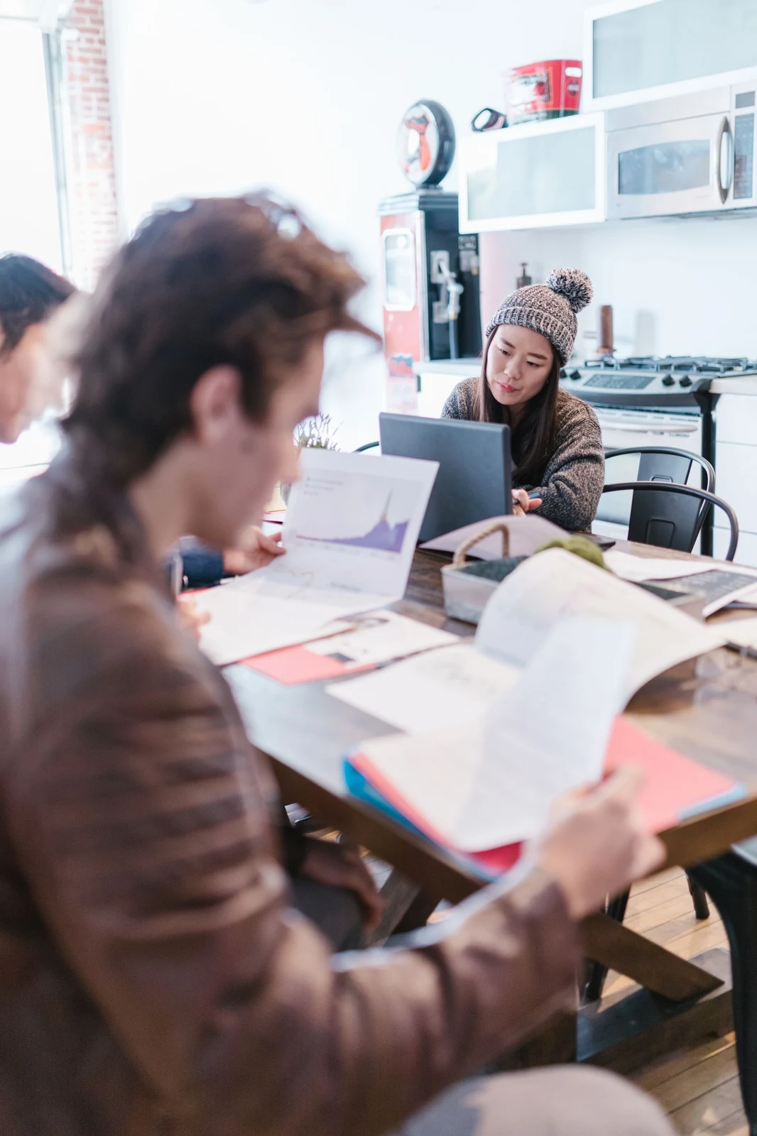 Colleagues reviewing work together around a table
